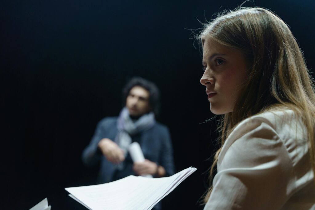 Actors rehearsing a scene with practice acting scripts.