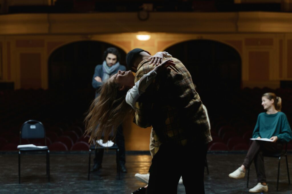 Actors in a dramatic rehearsal on a theater stage and learning how to become an actor with no experience