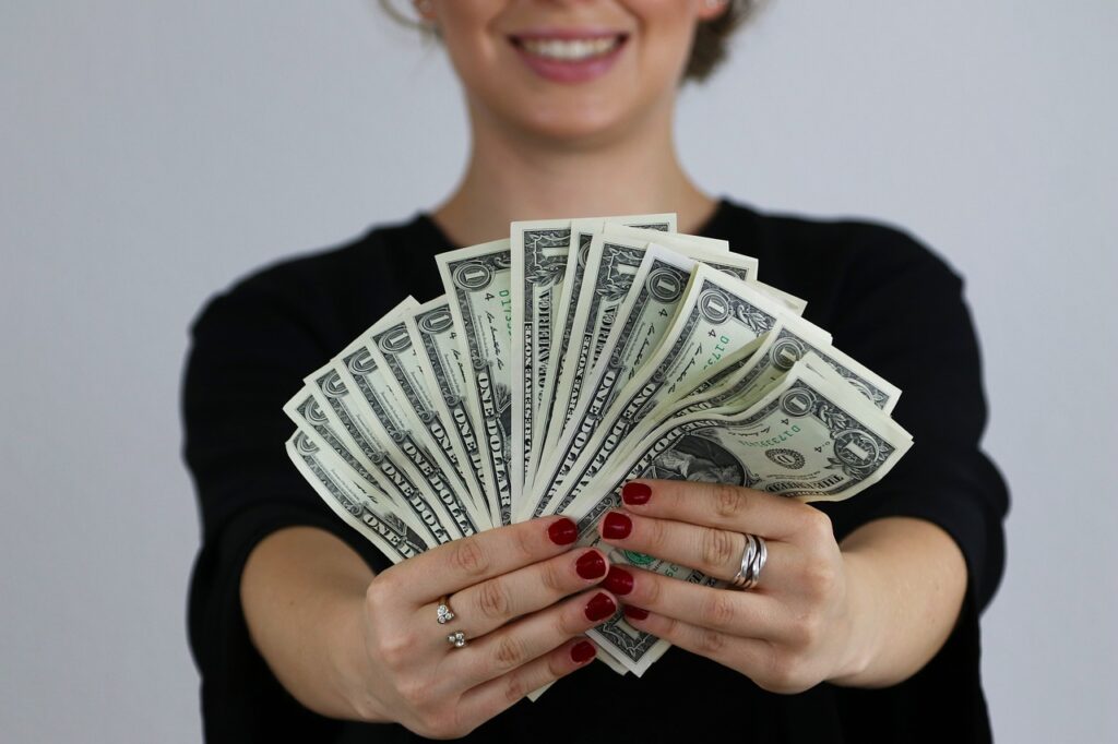 Actors need multiple streams of income to cover the cost of acting. Actor holding money.