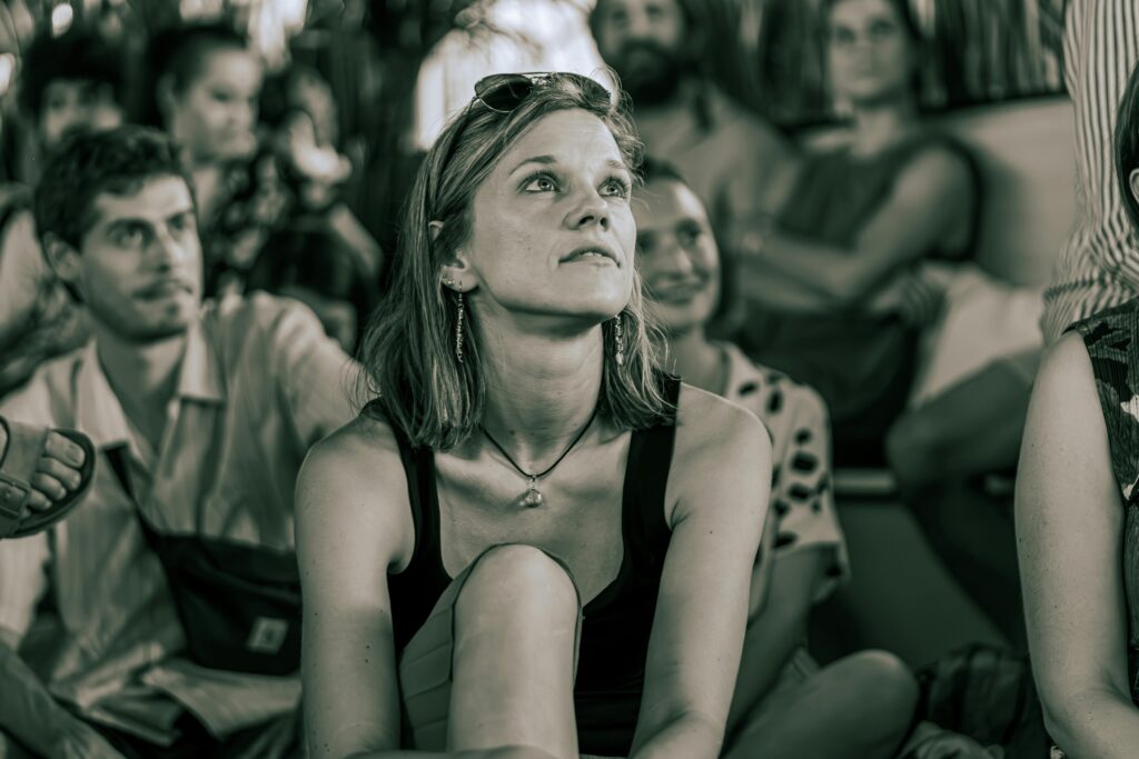 A group of actors auditing an acting teacher and other actors in acting classes.