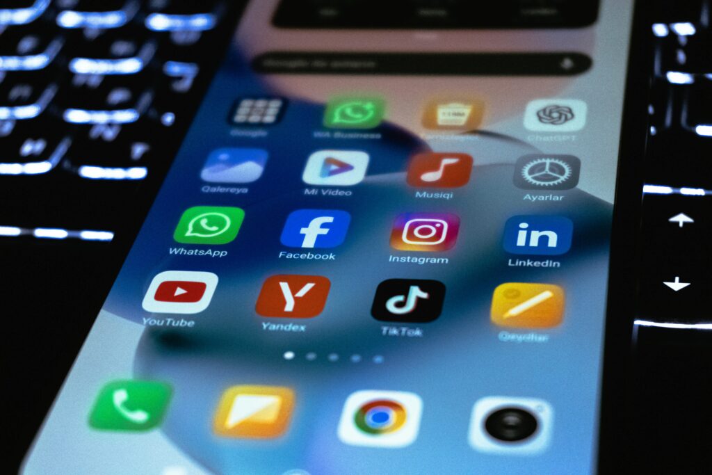 Close-up of a smartphone screen showing popular social media apps where you can find acting studios free acting classes, lessons, and tips on their social media accounts.