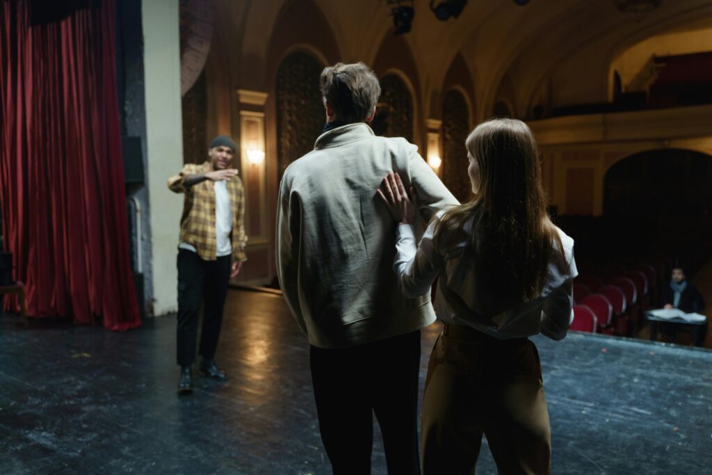 Actors in acting classes and rehearsing on stage, capturing the art and emotion of theater.