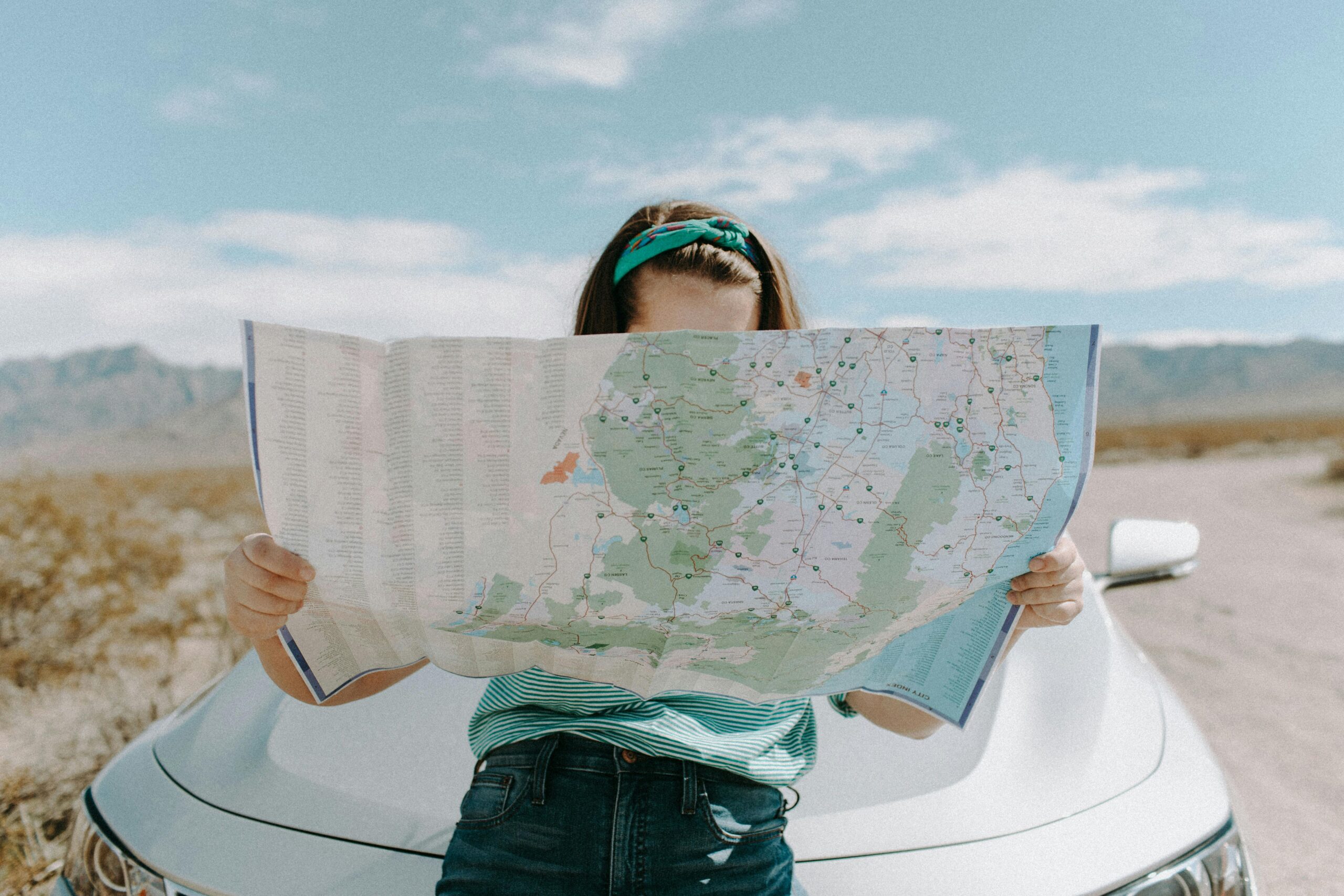 An actor holds a map while searching for local acting classes near them.